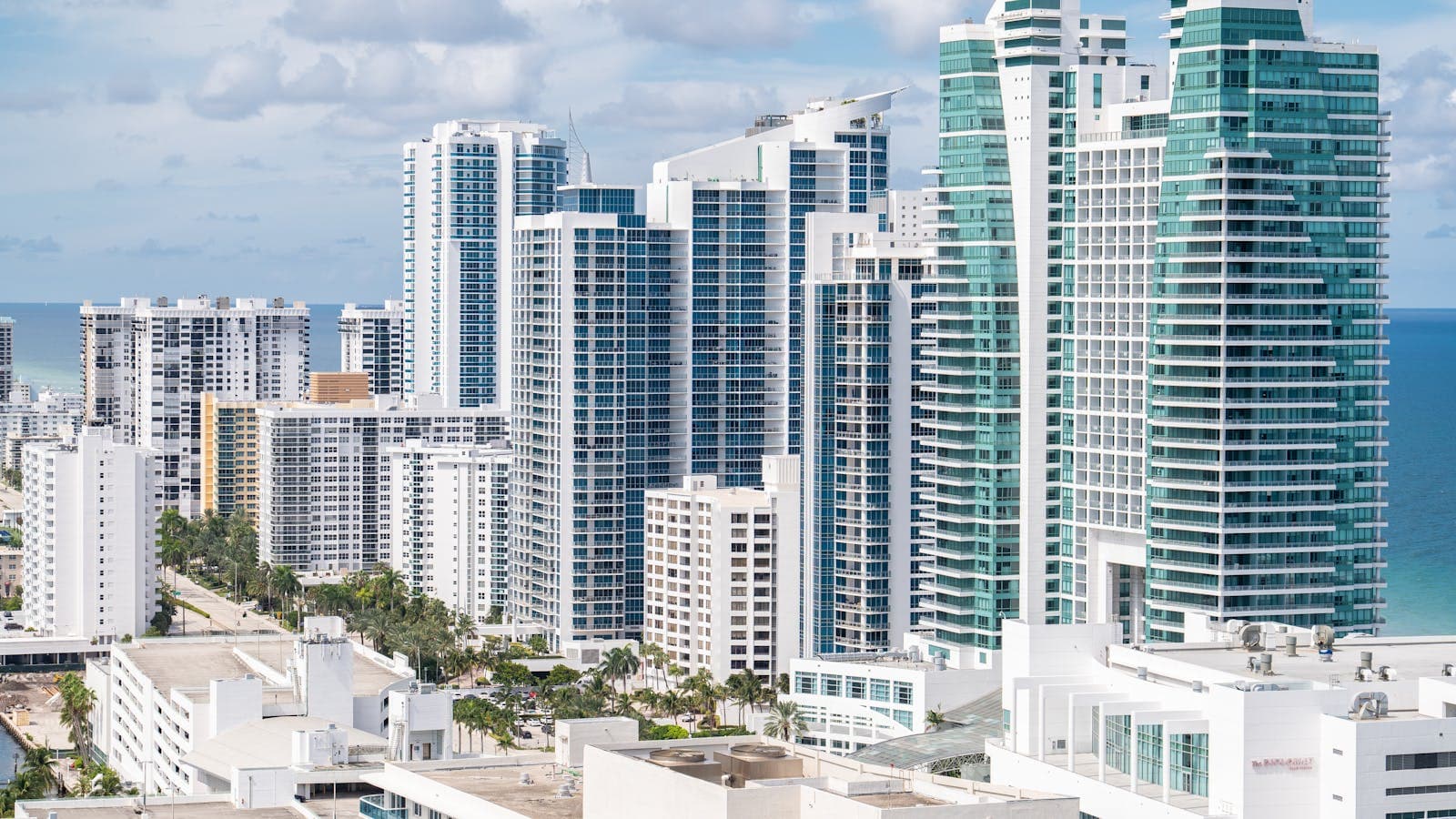 Florida condominium building exterior with palm trees