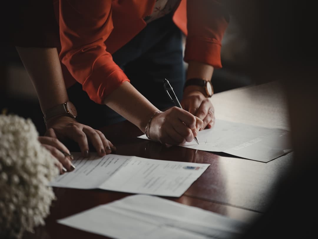 Florida homeowner reviewing foreclosure documents at a kitchen table with a laptop open to legal resources
