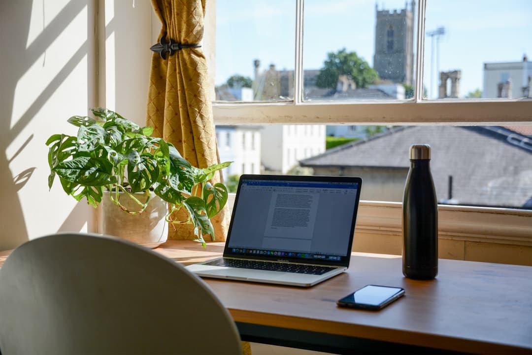Self-employed Florida homeowner reviewing loan modification documents at a home office desk with mortgage paperwork and a laptop