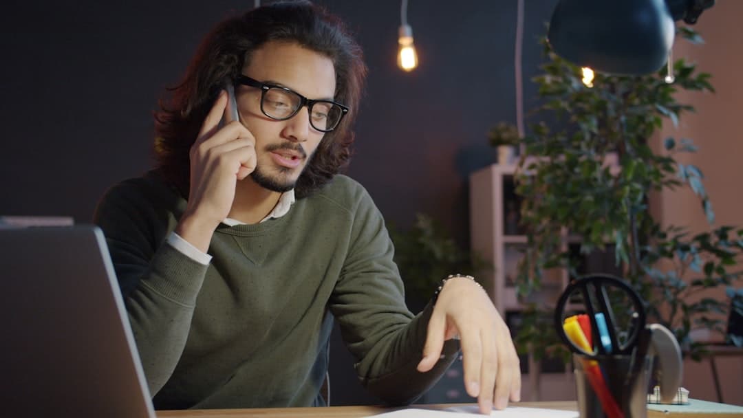 Mortgage paperwork and phone on a desk representing servicer communication